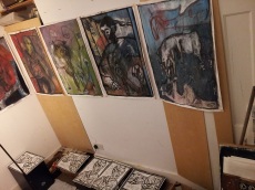 Upper row of oil paintings. Lower row of self-portrait woodcuts. All drying.